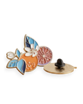 Pin esmaltado botánico Terreta con naranja, azahar y hojas azules sobre fondo blanco, anverso y reverso